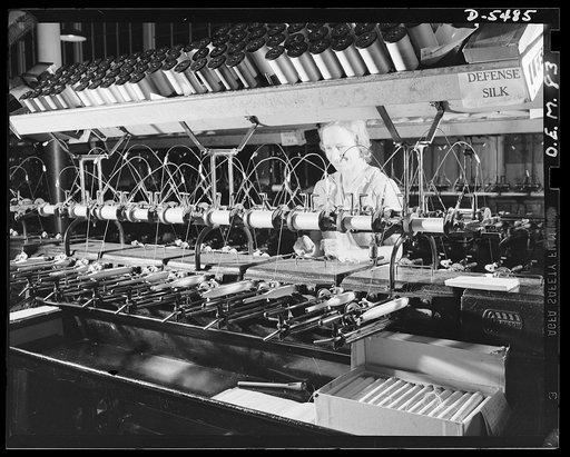 Production. Parachute cloth and shrouds. The quilling operation, early in the making of parachute cloth, consists of winding the fine nylon thread from spools onto small quills. The threads will later be woven into the parachute cloth