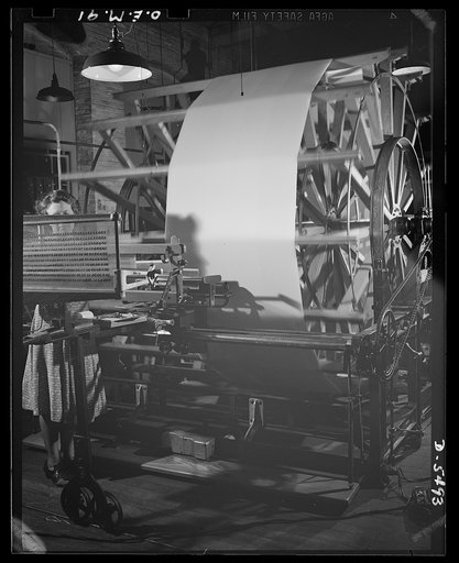 Production. Parachute cloth and shrouds. Warping operation in preparing silk for parachute cloth manufacture in an Eastern plant. Looking toward the reel on which the silk is wound in preparation for the weaving machine