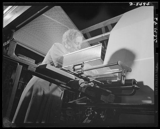 Production. Parachute cloth and shrouds. Warping nylon threads for use in the making of parachute cloth in an Eastern plant. This picture shows the threads coming from the nylon spools to the warping machine. The number of threads is 1,000. When one thread breaks, an electric switch stops the operat
