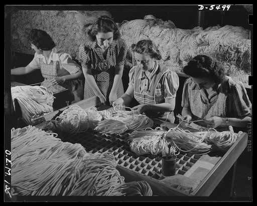 Production. Parachute cloth and shrouds. Inspecting parachute shroud lines before they are packed and shipped from an Eastern plant. All the inspectors are good Americans of foreign descent. They represent, Irish, French, Italian and Hungarian ancestry