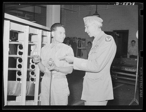 Training. Brooklyn Avaiation Center. Major John Donaldson, U.S. Army Air Corps, discusses the construction of an airplane wing section with Kay Hoo Chung at the Brooklyn Aviation Trade Center. Major Donaldson, a veteran of the first world war, is the head of the school, which trains workers for airp