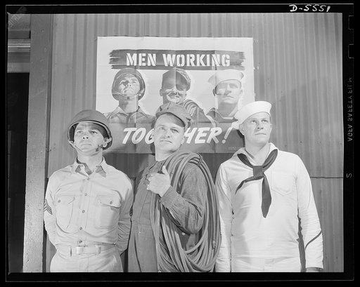 A poster comes to life. Sergeant French L. Vineyard, welder George Woolslayer, and Aviation-radio Chief John Marshall Evans pose before the poster which has made their faces nationally known. The poster before which they stand is displayed in a plant of the Allegheny-Ludlum Steel Corporation where W