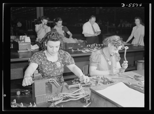 Production. Aircraft engines. Woman's place is on the inspection line in this Midwest aircraft plant where increasing numbers of young girls are being employed for this exacting work. Frances Busch and Lorraine Onobato put in five full days a week inspecting and gauging oil pipes for airplane engine