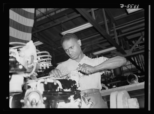 Production. Aircraft engines. A skilled mechanic and determined war worker, Zed W. Robinson, proves that skin pigment bears no relation to efficiency of work. He's one of many Negroes employed in a large Midwest aircraft plant in skilled and semi-skilled capacity. Tightening bolts of a cylinder barr