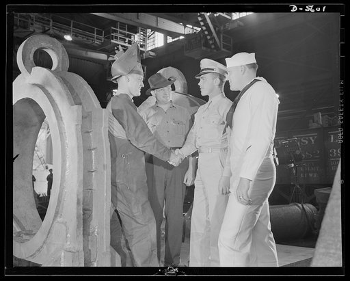 A poster comes to life. "I've been waitin' for this moment," said George Woolslayer as he shook hands with his poster-model colleagues, Sergeant Vineyard and Chief Evans, "and I'm mighty proud." Although Woolslayer was somewhat more voluble than his service friends, all of the men admitted to being 