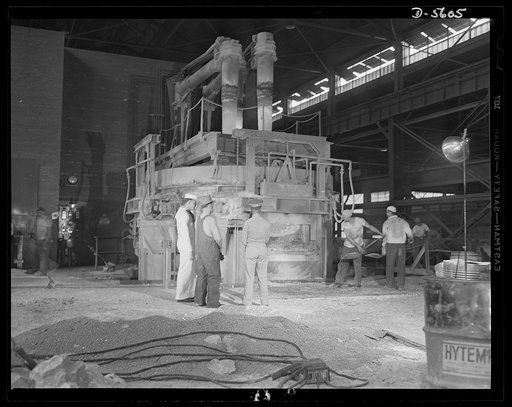 A poster comes to life. The lives of these men depends upon the others. Soldier, sailor and welder watch tireless steelworkers at one of Allegheny-Ludlum's mills as they shovel alloy materials into a fifty-ton electric furnace which produces high alloy steel for ships and guns. Thus the three who po