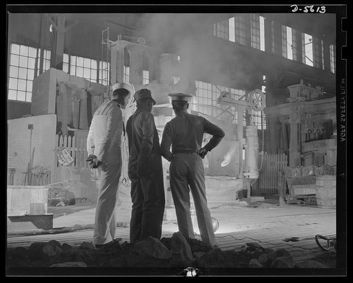 A poster comes to life. Standing in the white-hot glare of a twenty-five ton electric furnace where scrap metal and alloy materials are combined under terrific heat treatment, welder George Woolslayer tells Sergeant Vineyard and Chief Evans how this molten metal will be forged into the guns and tank