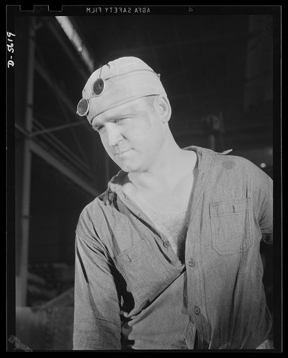 A poster comes to life. He doesn't wear a sergeant's stripes or a captain's bars, but he's an essential soldier of the home front, just as vital to the winning of this war as the men in uniform on America's myriad battlefields. A steelworker, whose job includes shoveling limestone into an electric f