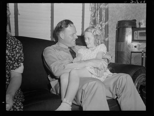 A poster comes to life. "She's just about your age, too." Aviation-radio Chief John Evans tells Georgia Ann Woolslayer about his own daughter in the course of the servicemen's visit at the Woolslayer's house. The comforts of home looked pretty good to Evans and Sergeant Vineyard who spent Sunday wit