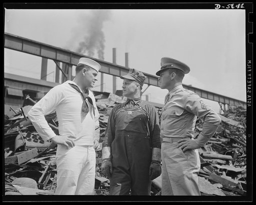 A poster comes to life. Background: the raw materials. Foreground: the men who mould and use them. Composite result: winning a war. The three men are shown in the scrap yards of a plant of Allegheny-Ludlum. In that heap in the background, incidentally, may be that old bedspring or stove cover that y