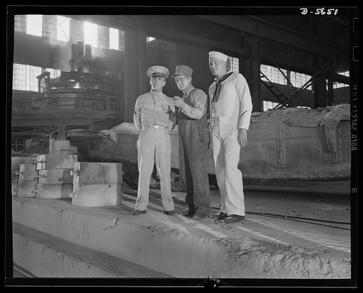 A poster comes to life. "Now, over there is..." For six days, Woolslayer acted as guide for his Army and Navy companions and even then failed to cover the entire mill. Note, in left background, an electric furnace in operation. Allegheny-Steel, Pittsburgh, Pennsylvania