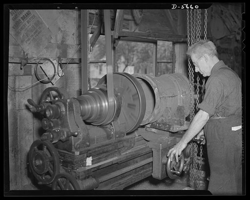 "Me and the old gent." Jake Sparling, sixty, head of the two-man shop of the Sparling Pulley Manufacturing Company, Bay City, Michigan. He and his seventy-nine-year-old ex-lumberjack helper were recognized by Donald Nelson as the only two-man labor- management war production drive committee in the U
