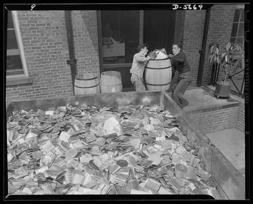 Tin can alley leads to victory. They've got a heavy load, but it's one that will weigh a lot heavier on Hitler. These cans collected by door-to-door pickup will be on their way to a detinning plant. The metals reclaimed from them will make vital war equipment