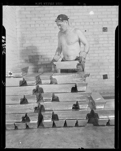 Tin can alley leads to victory. "Pig" of pute tin, all recovered from discarded cans, are stored in the vault of an Eastern detinning plant, pending their reuse in the form of airplane motor bushings, gas mask canisters and other vital war accessories