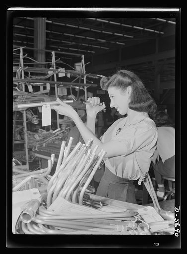 Production. Willow Run bomber plant. Inspection of more than a thousand separate tubing pieces composing the fuel, hydraulic, de-icing and other systems in a bomber is a highly important job. This young employee at the giant Willow Run plant uses her tiny flashlight to discover any internal defects 