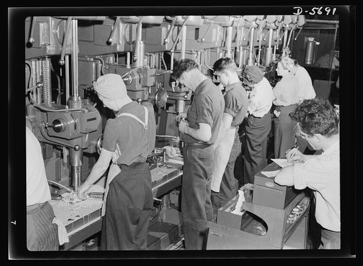 Production. Willow Run bomber plant. Drill press lineup, 1943 style. Both men and women man the machines which are turning out parts for America's bomber planes at Willow Run, Michigan. Ford plant, Willow Run