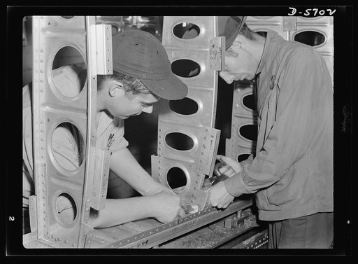 Production. Willow Run bomber plant. The outer wing panel of a bomber undergoes assembly in the giant Willow Run plant. When finished, this section will be removed and cranes will install another section in the fixture. Ford plant, Willow Run
