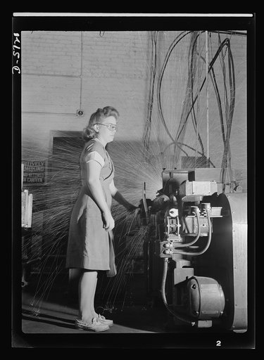 Women in industry. Tool  production. Eyes averted from the white shower of sparks, this young employee of a drill and tool plant touches the button that welds drills to their shanks. She's one of nearly 1,000 women who have replaced men at the production machines of this Midwest factory. Republic Dr