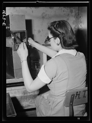 Women in industry. Tool  production. Testing small diameter, high-speed twist drills, this young woman employed by a Midwest drill and tool company is one of America's women "behind the men behind the guns." Drills must be perfectly made so that the nation's war weapons can be built to accurate spec
