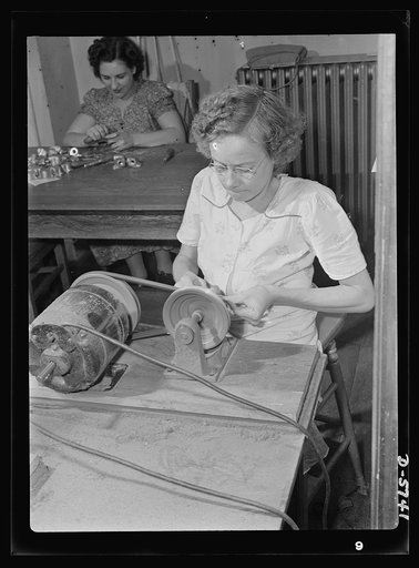 Manpower. Handicapped workers. With no previous industrial experience, Thelma Lilly learned to operate this burring machine three months ago and today is working full-time on Y's for America's battleships of the air. Despite crippling effects of arrested tuberculosis of the spine, Miss Lilly is one 