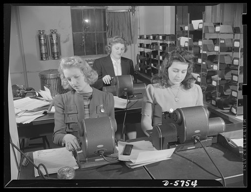 Office equipment used by the War Production Board (WPB). Check-signing machines used by the WPB for signing preference ratings to validate priorities documents. The small machine at the left is used more frequently than the larger older models at the right