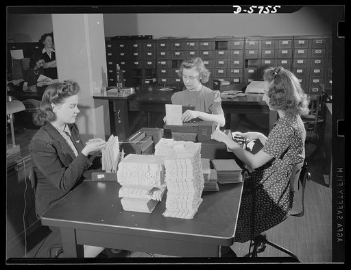 Office equipment used by the War Production Board (WPB). Girls operating a card punching machine for the machine tools section of the WPB. The cards show tools on order, delivery date promised, name of purchaser, and other information concerning the progress of machine tool production