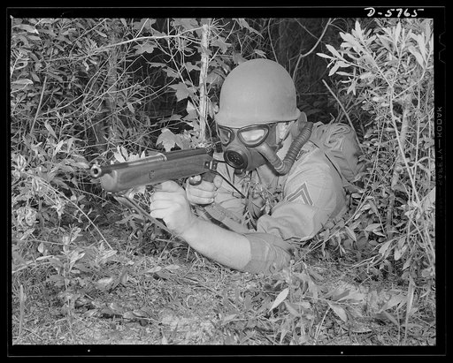 New River, North Carolina. Marine Corps submachine gunners. An efficient gas mask and a deadly Johnson submachine gun are part of the kit of fighting tools carried by this leatherneck in training at New River, North Carolina. The gun, a new Marine Corps weapon, is said to have a lot of authority. Ma