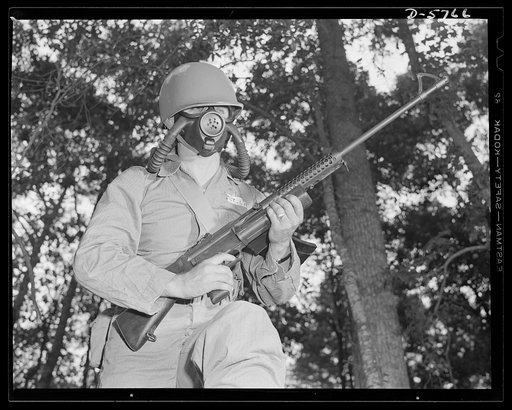 New River, North Carolina. Marine Corps submachine gunners. An efficient gas mask and a deadly Johnson submachine gun are part of the kit of fighting tools carried by this leatherneck in training at New River, North Carolina. The gun, a new Marine Corps weapon, is said to have a lot of authority. Ma