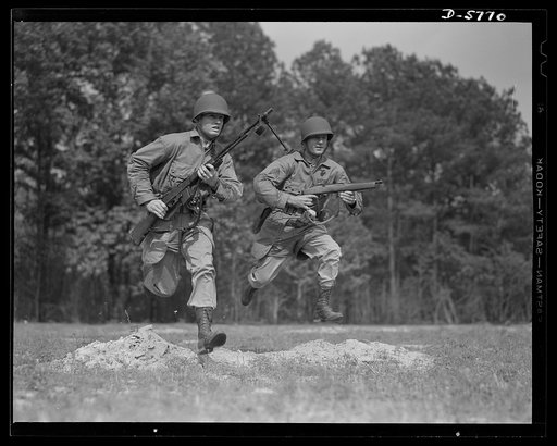 New River, North Carolina. Marine infantry. The guns that the fighting Marines bring nowadays "to every land and clime" are many and varied--and pack a lot of authority. These charging leathernecks, in training at New River, North Carolina, are carrying, at left, a Browning automatic rifle; at right