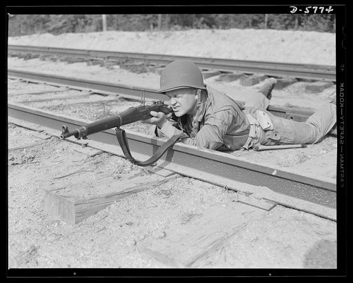 New River, North Carolina. Marine infantry. The Garand rifle [not shown here] does some of its best work in the hands of a hard, capable leatherneck. This Marine, in training at New River, North Carolina, knows how to make use of all the fighting advantages it offers. Marine srtg barracks, New River