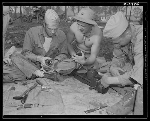 New River, North Carolina. Marine truck transport units. Marine Corps transport workers study the assembly of one of the many weapons the leathernecks use in war exercises at New River, North Carolina. Marine barracks, New River, North Carolina