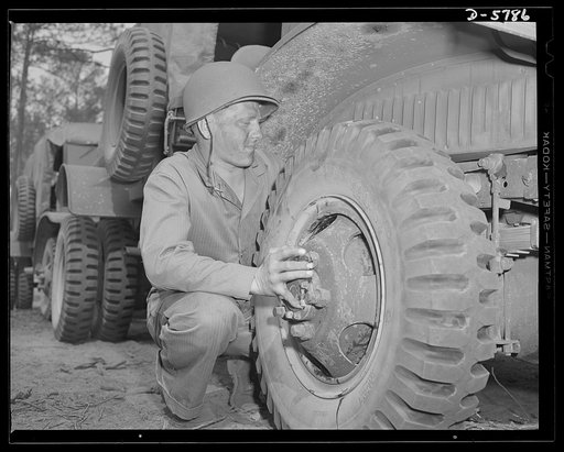 New River, North Carolina. Marine truck transport units. Marine transport workers in the fleet force are the most expert of tire changers. This man, in training at the New River, North Carolina base, takes them all ways: big ones, little ones, any way they come. Marine barracks, New River, North Car