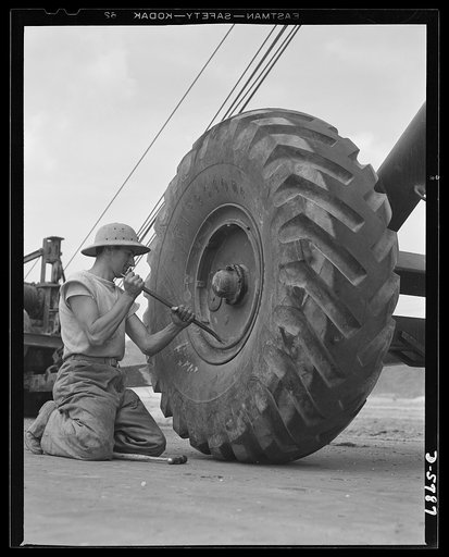 New River, North Carolina. Marine truck transport units. Marine transport workers in the fleet force are the most expert of tire changers. This man, in training at the New River, North Carolina base, takes them all ways: big ones, little ones, any way they come. Marine barracks, New River, North Car