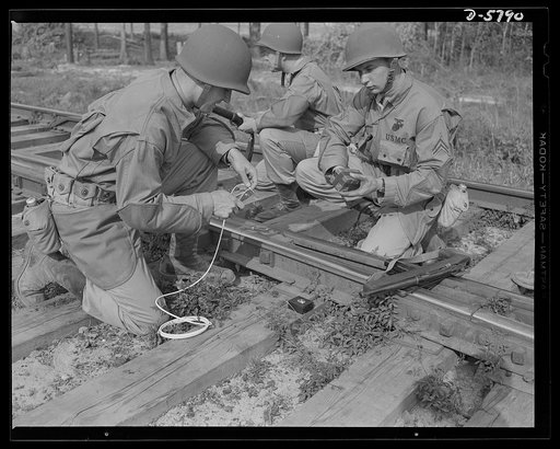 New River, North Carolina. Marine Corps demolition squads. The leathernecks can destroy railway systems, as well as build and operate them. A Marine demolition squad, in training at the New River, North Carolina base, prepares to blow out a section of track. Two men set the charge while two others s