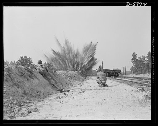 New River, North Carolina. Marine Corps demolition squads. This demolition charge would have blown out a section of railroad track if it had been set under the rails instead of in a bank of earth. A Marine demolition squad, in training at the New River, North Carolina base, goes through the full rou
