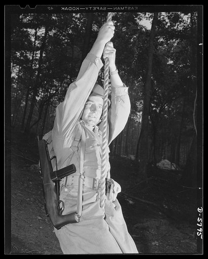 New River, North Carolina. Marines in training. "Walking" up a rope hand over hand with full combat pack is an approved toughening-up exercise at the New River, North Carolina Marine base. Leathernecks who go in for conditioning routines like this will give the Axis some new ideas of what a hard-boi