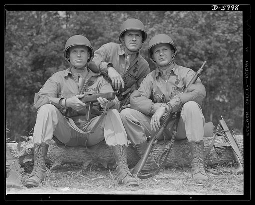 New River, North Carolina. Marines in training. Even toughened leathernecks appreciate a few minutes of rest after a long period of grueling action. But even while resting, these Marines, in training at New River, North Carolina, are very much on the alert. Marine barracks, New River, North Carolina