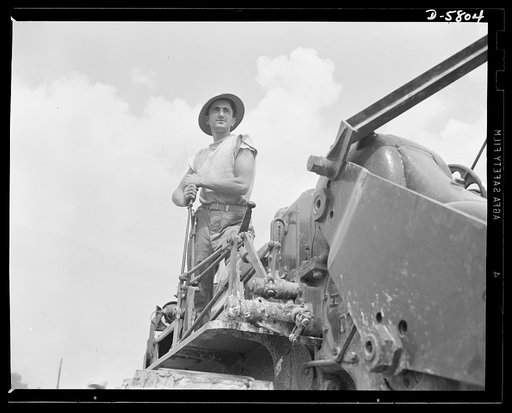 New River, North Carolina. Marines in training. The Marines take any job in stride--they can build as efficiently as they can demolish. This brawny leatherneck, operating earth-moving equipment at New River, North Carolina, is ready for combat service on a minute's notice. Marine barracks, New River