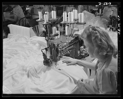 Production. Parachute making. This machine, operated by Joyce Puopolo, sews four parachute canopy seams at one time. Before joining the war production army, Miss Puopolo was a motorcycle stunt rider in Hollywood. Her husband, who also worked in movie thrillers, is now at a naval air base. Pioneer Pa