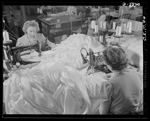 Production. Parachute making. Not gowns for a bal, but chutes for a fall are these yards and yards of silk, here being stitched together in an Eastern parachute manufacturing plant. Pioneer Parachute Company, Manchester, Connecticut