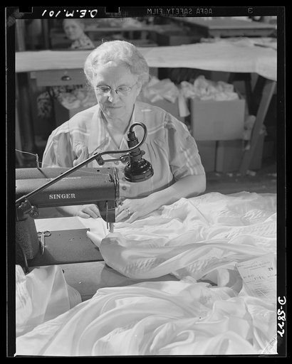 Production. Parachute making. Mother of a sergeant in the Army, wife of a World War I veteran, Mrs. Emilia Gworek is a soldier in her own right. Here she sews parachute seams during the night shift of an Eastern plant. In the daytime, she is active in Red Cross work and is president of her American 