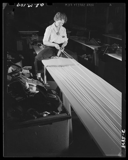 Production. Parachute making. Two of her brothers are in the Army, two brothers are World War I veterans. Perhaps that's why Bonnie Bonness finds attaching shroud cords to parachute straps in this Eastern factory more important than her former profession: dancing in New York's Greenwich Village nigh