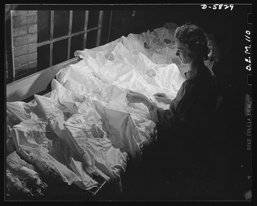 Production. Parachute making. What at first seems to be a department store lingerie counter is actually pilot chutes lined up for inspection at an Eastern parachute factory. A pilot chute is hooked up to every parachute. Pioneer Parachute Company, Manchester, Connecticut