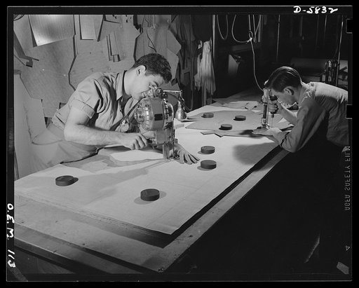 Production. Parachute making. The utmost precision is required of these operators who are cutting and drilling parachute packs in an Eastern factory. Their work is under constant close supervision. Pioneer Parachute Company, Manchester, Connecticut