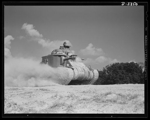 Fort Knox, Kentucky. M-3 tanks. The M-3 tank packs a wallop which the Axis is only beginning to feel. One of these capable monsters, with a tough American crew aboard, is put through its paces in the training area near Fort Knox, Kentucky