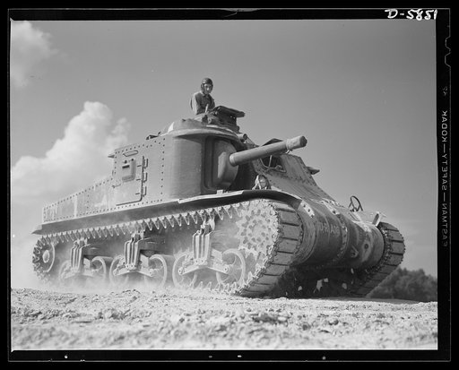 Fort Knox, Kentucky. M-3 tanks. The M-3 tank packs a wallop which the Axis is only beginning to feel. One of these capable monsters, with a tough American crew aboard, is put through its paces in the training area near Fort Knox, Kentucky