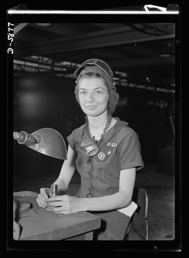 Women in industry. Aircraft motor workers. A million dollar baby, not in terms of money but in her value to Uncle Sam, twenty-one-year-old Eunice Hancock, erstwhile five-and-ten-cent store employee, operates a compressed-air grinder in a Midwest aircraft motor plant. With no previous experience, Eun
