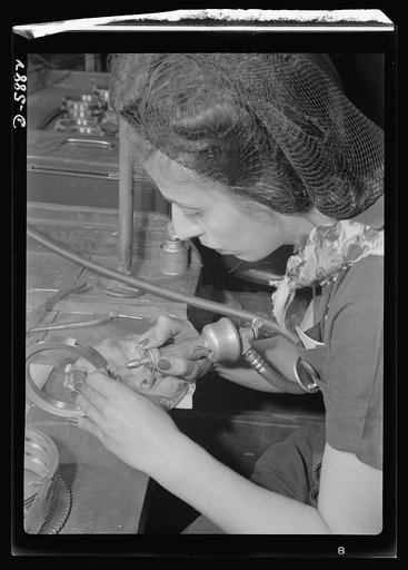 Women in industry. Aircraft motor workers. Using a small rotary air grinder, this young employee of a Midwest aircraft motor plant performs a delicate job on a gear spacer that will see duty in the mechanism of one of America's battleships of the air