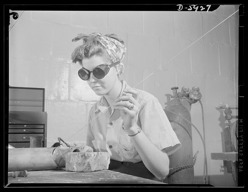 Women airport workers. Evelyn Spangler, eighteen-years-old, is just as proficient at acetylene torch welding as any of the men welders in the Pennsylvania Central shops, according to Johnny Shore, her instructor. Evelyn learned welding rudiments from her father in Christiansburg, Virginia, got more 
