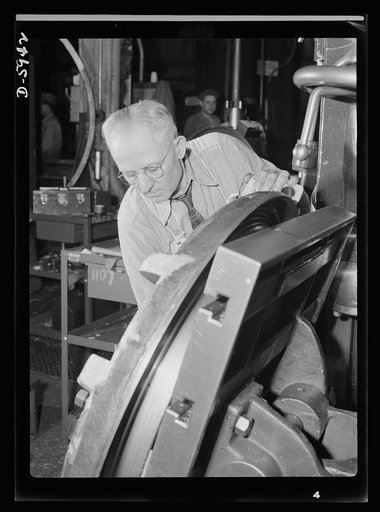 Manpower. Americans all. Born in Rumania, George Sackwar is doing what he can to shoot up the Axis - not with a gun but with the radial drill on which he makes parts for medium tanks. One of many hundreds of loyal, foreign-born Americans who work in this large Midwest tank plant, Sackwar is proud of